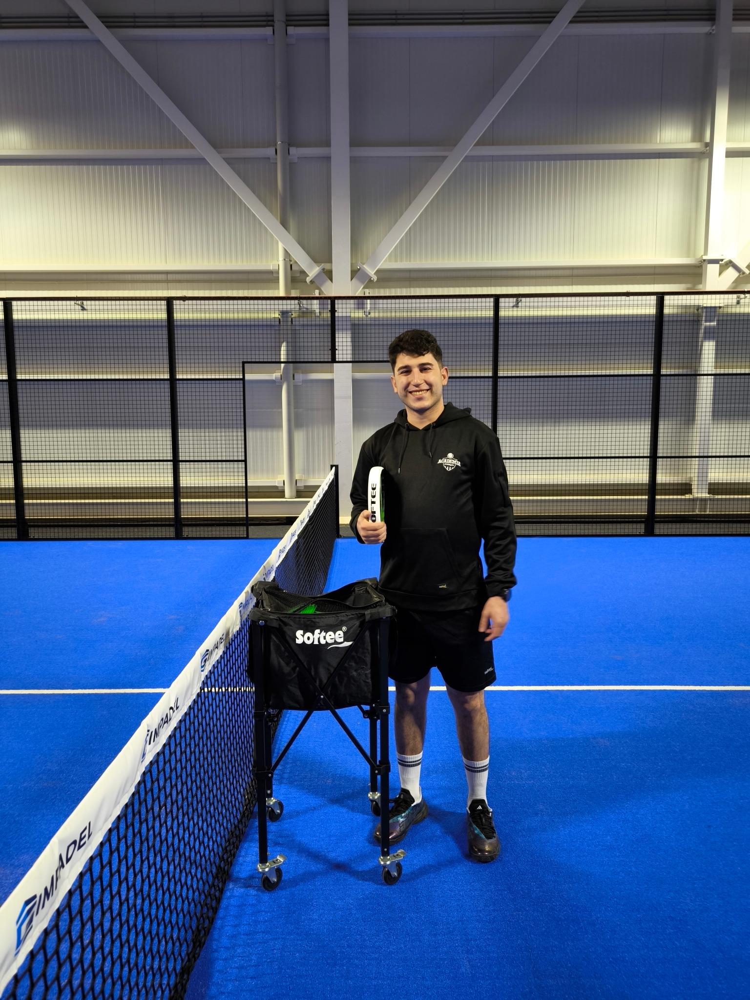 Raulito coaching on an indoor padel court